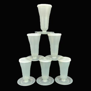 May include: A set of six translucent, frosted plastic cups with matching lids, arranged in a pyramid stack. Each cup features a tapered body, a narrow base, and a wide, circular pedestal foot, creating a uniform, stackable design for beverage service.