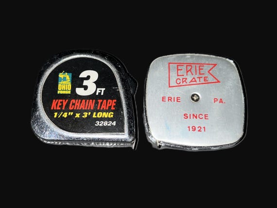 Vintage American-made tape measure repurposed as an EDC keychain — a tiny retro industrial artifact you actually use every day.