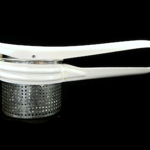 May include: White plastic potato masher with a stainless steel mesh base. The masher has a long handle with a lever to press down on the potatoes.