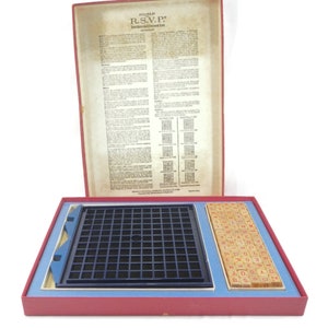 May include: A red, blue, and white game box with a blue grid and wooden letter tiles. The box lid has the text "SELCHOW & RIGHTER R.S.V.P. The Reversed Crossword Game".