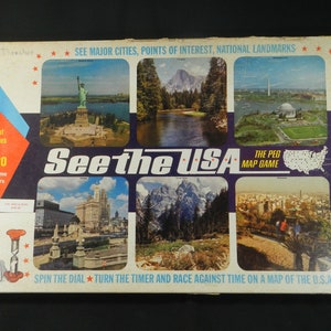 May include: A vintage board game box for "See the USA", a peg map game by Cadaco. The box features a colorful design with images of iconic American landmarks, including the Statue of Liberty, Yosemite National Park, and the Washington Monument. The game is described as a "family game" for 2 to 6 players.