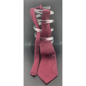 May include: A burgundy tie with a subtle diagonal weave pattern. The tie is displayed on a clear, spiral-shaped hanger, showcasing its texture and design. The tie's color is a deep red with a hint of purple.