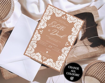 May include: A brown wedding invitation with white floral designs. The invitation reads "With the love of our families, Estelle & David, Join us as we celebrate our wedding, September 25, 2023, at 7:00 PM, 123 Anytown St, Anytown, City".