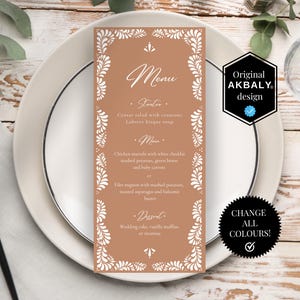 May include: A menu card with a brown background and white floral border is placed on a white plate. The menu includes starters, main courses, and desserts. The text "Menu" is at the top, with the words "Original AKBALY design" and "CHANGE ALL COLOURS!" on the side.