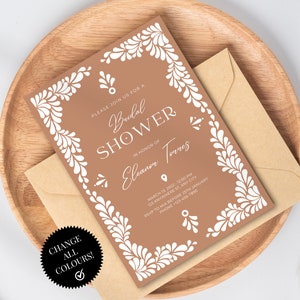 May include: A brown invitation with a white floral border and the text "Please join us for a Bridal Shower in honor of Eleanor Torres" with the date, time, and location of the event.