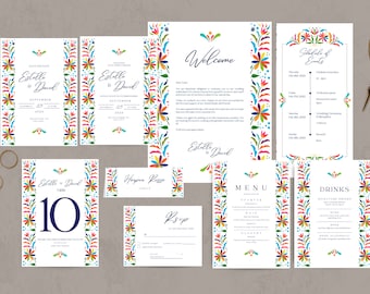 May include: A collection of wedding stationery with a colorful floral design. The set includes invitations, a welcome letter, a schedule of events, a table number, a place card, an RSVP card, a menu, and a drinks menu. Gold scissors and rings are also present.