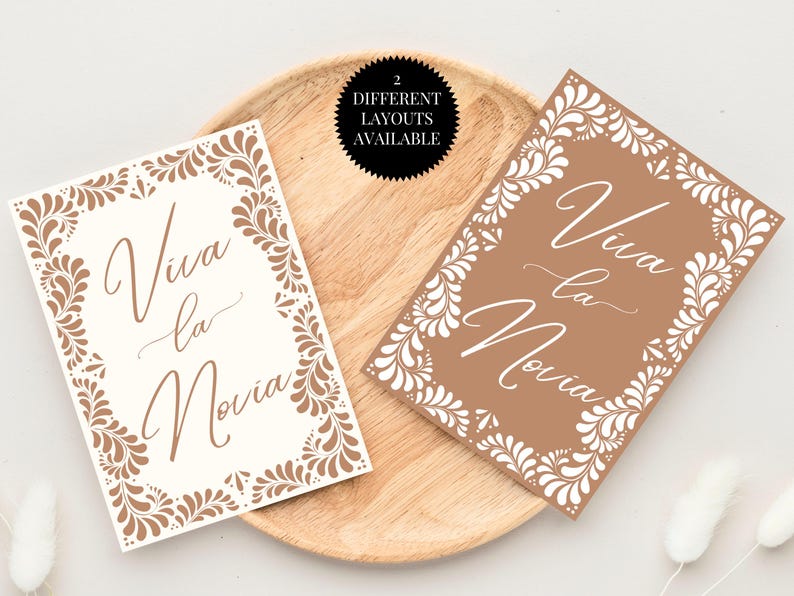 May include: Two printable designs for a wedding sign. The sign says "Viva la Novia" in a decorative script font. The designs feature a brown background with a white floral pattern.