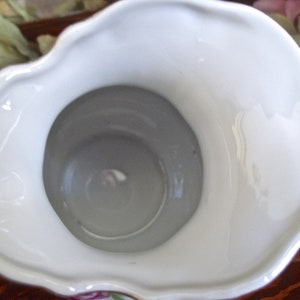 Peut inclure: Pichet en porcelaine blanche avec un bord festonn&eacute; et un motif floral. Le pichet a une large ouverture et un int&eacute;rieur blanc lisse.