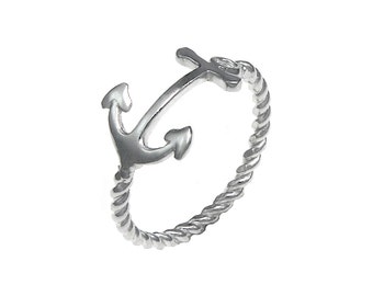 May include: A silver ring with a twisted rope design and an anchor charm.