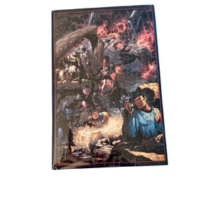 May include: A comic book featuring a detailed, action-packed illustration. The cover art depicts a dynamic scene with multiple characters, explosions, and a dark, dramatic color palette. The artwork is highly detailed.