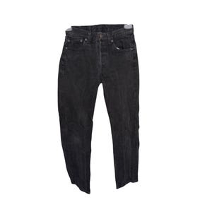 May include: A pair of black denim jeans. The jeans have a button fly, five pockets, and a faded appearance. The jeans are hanging on a hanger against a white background.