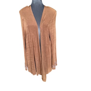 May include: A long, open-front cardigan in a warm brown hue. The sleeves are long, and the cuffs are adorned with a decorative pattern. The fabric has a soft, flowing drape, and the cardigan is displayed on a mannequin.
