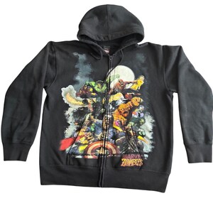 May include: Black zip-up hoodie featuring a colorful graphic of Marvel Zombies characters. The design includes the Hulk, Spider-Man, and Captain America. The hoodie has a hood and a full-length zipper. The words "Marvel Zombies" are printed on the bottom right.