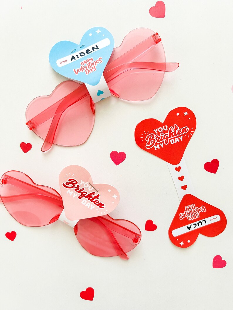 May include: Valentine's Day gift tags with heart-shaped sunglasses. The tags are red and pink with white text that says "You brighten my day" and "Happy Valentine's Day".