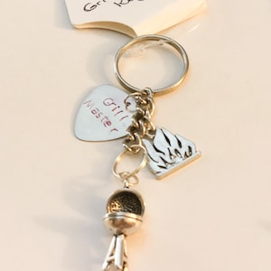 Grill Keychains with BBQ grill, flames and special stamped message on a guitar pick