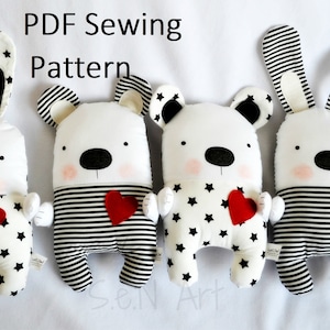 May include: Four handmade plush toys: two bunnies and two bears. The white plush toys have black star or stripe patterns, red heart accents, and black eyes. The text "PDF Sewing Pattern" is at the top.