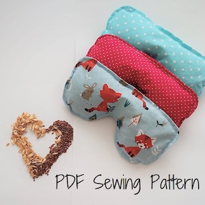 May include: Three fabric eye pillows with different patterns. The top pillow is light blue with white polka dots, the middle pillow is red with white polka dots, and the bottom pillow is light blue with a woodland animal print. The text "PDF Sewing Pattern" is written below the pillows.