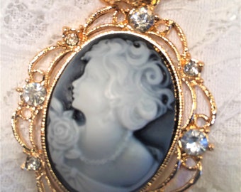 Cameo Pendant Necklace, Gold Tone Setting and Gray Cameo Background Filigree Gold Edge with Clear Rhinestones, Nice Long Chain.