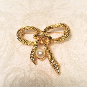 Knotted Gold Tone Bow Brooch with Braided Ribbon Strands and Faux Pearl Decoration, Bright Gold Fashion Brooch.