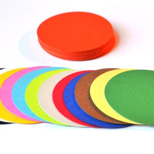 May include: A set of 12 colorful paper circles in various shades of red, orange, yellow, green, blue, purple, pink, and black. The circles are arranged in a semi-circle shape.