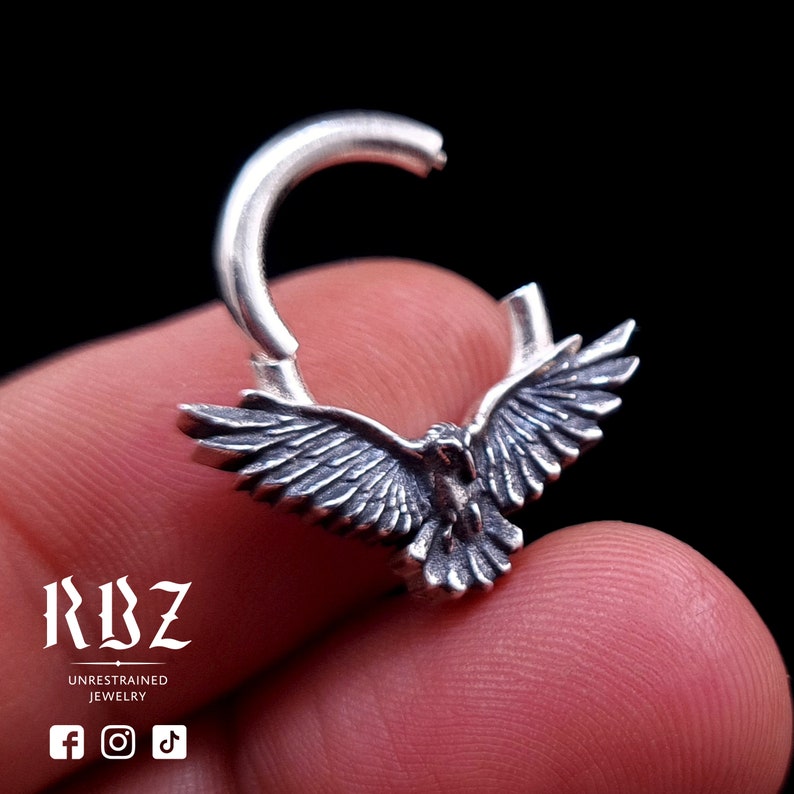 A highly detailed, Gothic crow / raven shaped clicker septum ring, made from solid Sterling silver, by RBZ Jewelry, open mode.