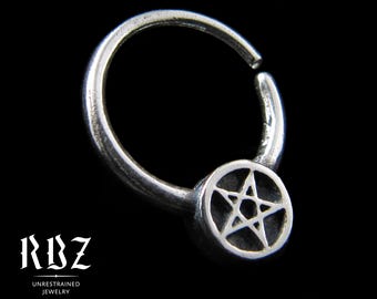 May include: A silver hoop ring featuring a circular charm with an embossed five-pointed star. The jewelry piece is displayed against a black background with the text RBZ UNRESTRAINED JEWELRY and Solid Sterling silver visible.