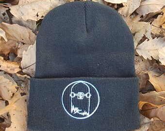May include: Black beanie with a white embroidered skateboard graphic on the front.