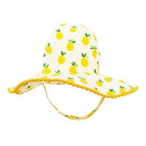 May include: A white sun hat with a yellow pineapple print and a yellow trim. The hat has a wide brim and a chin strap.