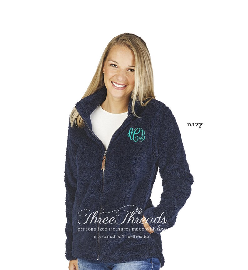 May include: A navy blue fleece jacket with a zip fastening and a monogrammed "HCB" on the chest. The jacket has a soft, fuzzy texture and is ideal for keeping warm in the colder months. Three Threads personalised treasures made with love. etsy.com/shop/threethreadsdsc