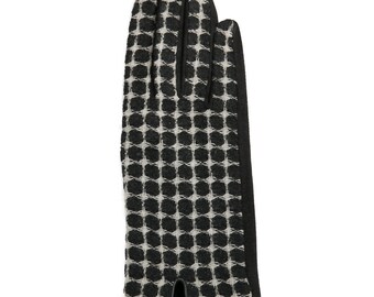 May include: Black gloves with a white geometric pattern. The gloves have a black cuff and are made of a soft, textured fabric.