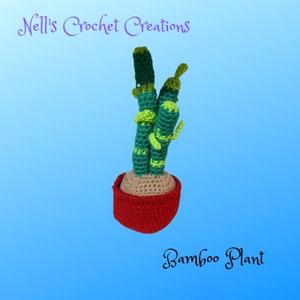 May include: A crocheted bamboo plant in a red pot. The plant is green and has a light green stem. The pot is a dark red color. The plant is on a blue background. "Nell's Crochet Creations" and "Bamboo Plant" are written in black text on the background.