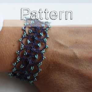 May include: A dark blue beaded bracelet with a delicate, intricate pattern. The bracelet is made with small, round beads and has a circular design.
