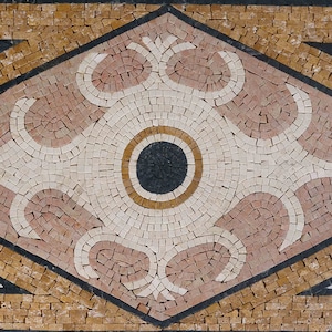 Könnte beinhalten: Eine dekorative Mosaikfliese mit geometrischem Design. Die Fliese zeigt eine zentrale Diamantform mit einem weißen und rosafarbenen Blumenmuster, umgeben von einem schwarzen und goldenen Rand. Die Diamantform ist vor einem Hintergrund aus kleinen, goldbraunen Fliesen platziert.