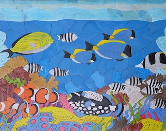 May include: A colorful mosaic mural depicting an underwater scene with various fish, coral, and seaweed. The fish are painted in shades of blue, yellow, black, and white. The coral is a vibrant orange and pink. The seaweed is a deep green.
