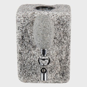 May include: A granite stone water dispenser with a polished chrome faucet. The dispenser has a rectangular shape with a textured surface and a gray and black speckled pattern. The faucet is positioned in the center.