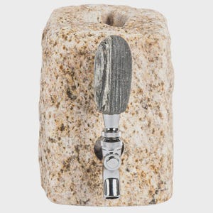 May include: A natural stone beer tap with a polished chrome faucet. The tap handle is made of a gray and white striped stone. The stone base has a rough, textured surface with tan and brown tones.
