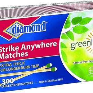 May include: A box of Diamond Strike Anywhere matches. The box is blue, red, and green, with the words "Strike Anywhere Matches" and "Extra Thick for Longer Burn Time." The box contains 300 large kitchen matches.