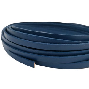 May include: A roll of dark blue leather cord, approximately 6 mm wide.
