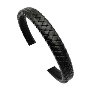 May include: A black leather bracelet with a braided design.