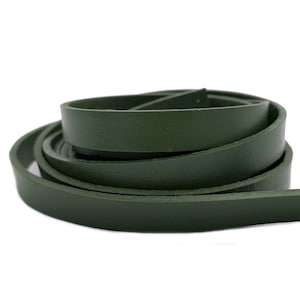 May include: A roll of dark green leather cord. The cord is approximately 1.2 cm wide.