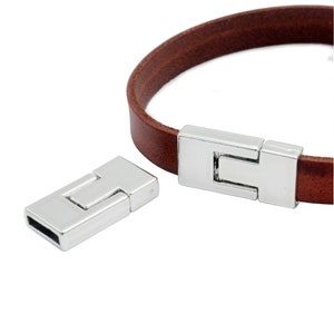 May include: Silver magnetic clasp for leather bracelets. The clasp is made of two pieces that snap together.