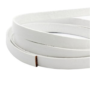 Könnte beinhalten: Eine Rolle weißes Lederband, etwa 6 mm breit.