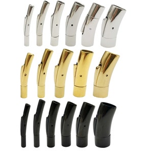 May include: Assortment of silver, gold, and black magnetic clasps for jewellery making. The clasps are made of metal and have a curved design.