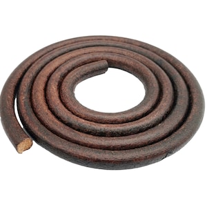 May include: A close-up of a brown leather cord, coiled into a circle. The cord is thick and has a textured surface.