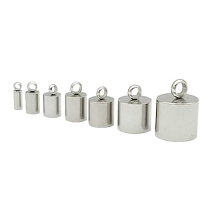 May include: A set of eight silver-toned metal pendant caps with a loop at the top. The caps are different sizes, ranging from small to large.