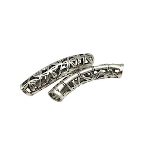 May include: Two silver metal bead caps with a decorative bamboo design. The caps are open on both ends and are designed to be used as end caps for jewelry making.