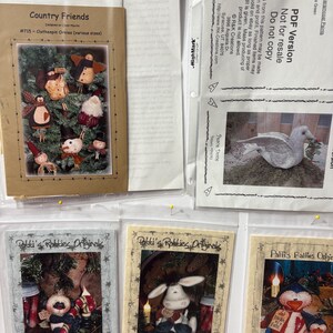 Op de afbeelding: Een verzameling knutselpatronen, waaronder "Country Friends" en "Patti's Ratties Originals". Het patroon "Country Friends" bevat wasknijperornamenten. Andere patronen tonen feestelijke, handgemaakte poppen en ornamenten, met tekst en illustraties.