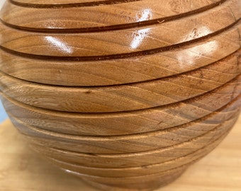 Hand turns on lathe oak bowl