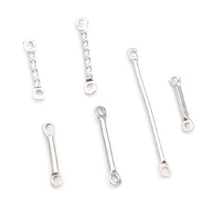 May include: Six silver metal connector pieces with loops on each end. The connector pieces are different lengths and styles.