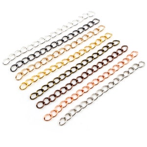 May include: Assortment of eight chain links in different metal finishes, including silver, gold, black, bronze, copper, and rose gold. The chains are all the same length and style, with a classic oval link design.
